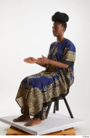  Dina Moses  1 dressed sitting traditional decora long african dress whole body 0016.jpg
